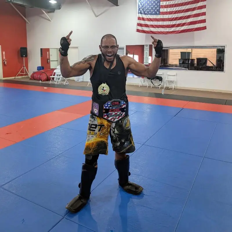 Coach TJ Simien with championship belt